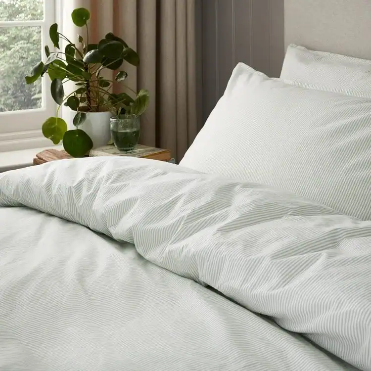 Close up of white and grey striped bedding. Calm Bedroom Ideas