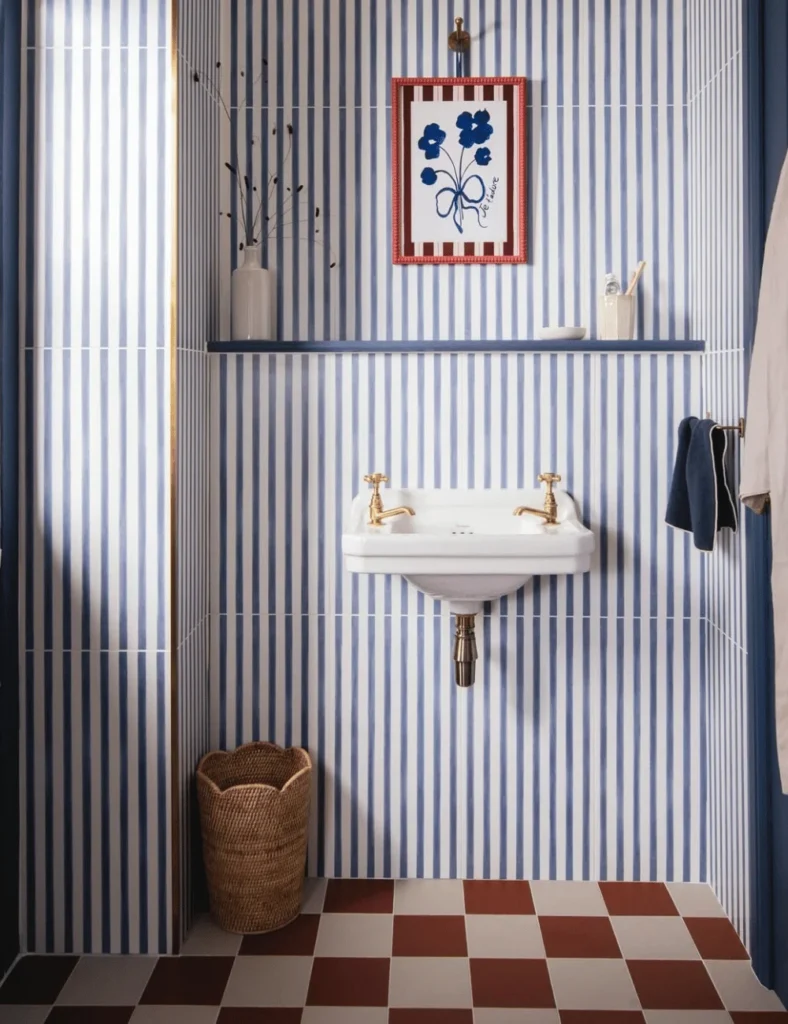bathroom with blue stripes tiles and orange checkerboard floor tiles