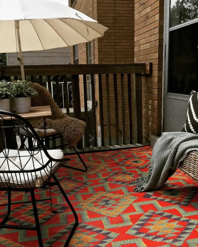 small patio with a large red aztec rug