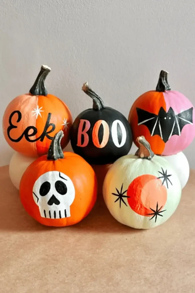 orange, white and pink painted pumpkins