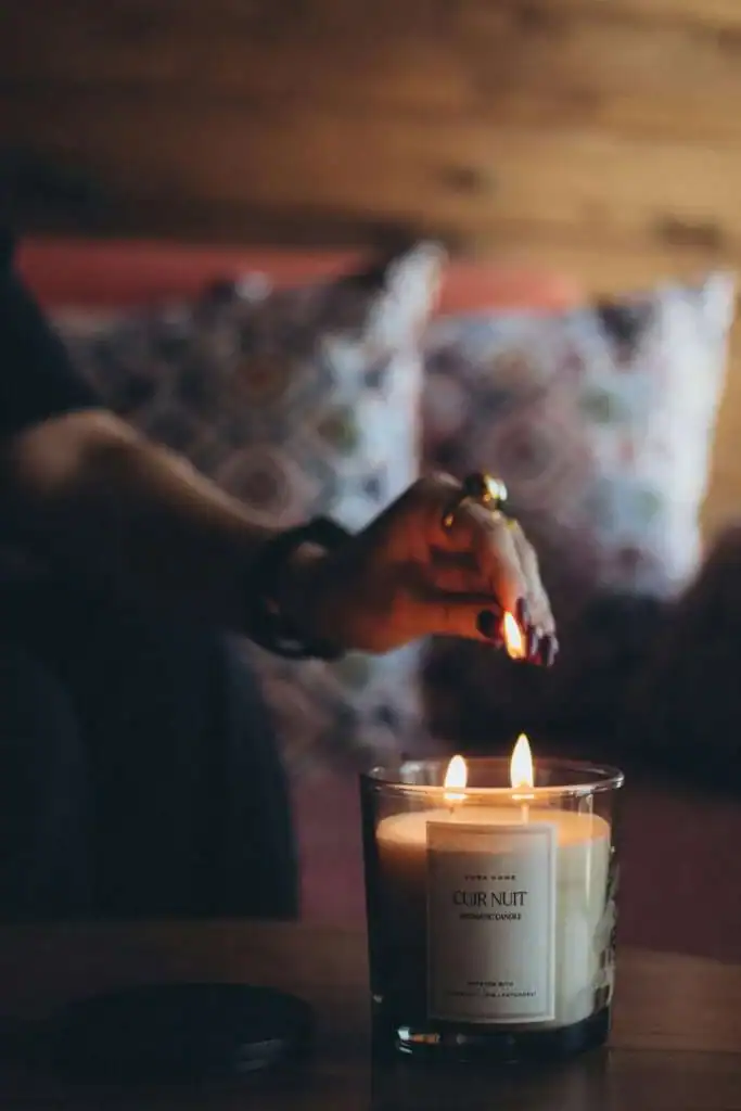 Person-lighitng-a-candle-in-a-dimly-lit-room.-Saturday-self-care-routine
