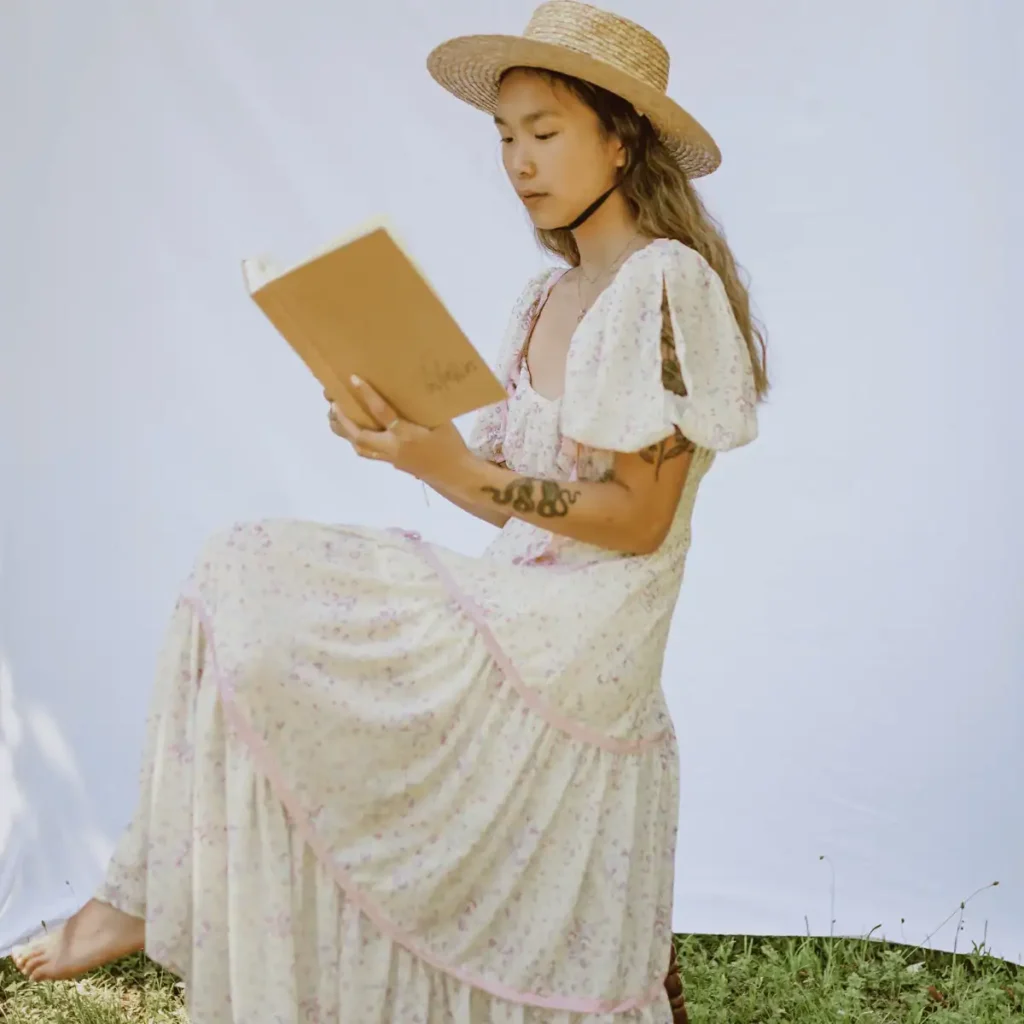 Self-Compassion-Journaling-Prompts.-Woman-in-a-summer-dress-reading