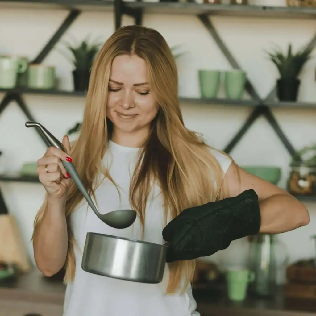 Woman-holding-up-a-pot-of-food