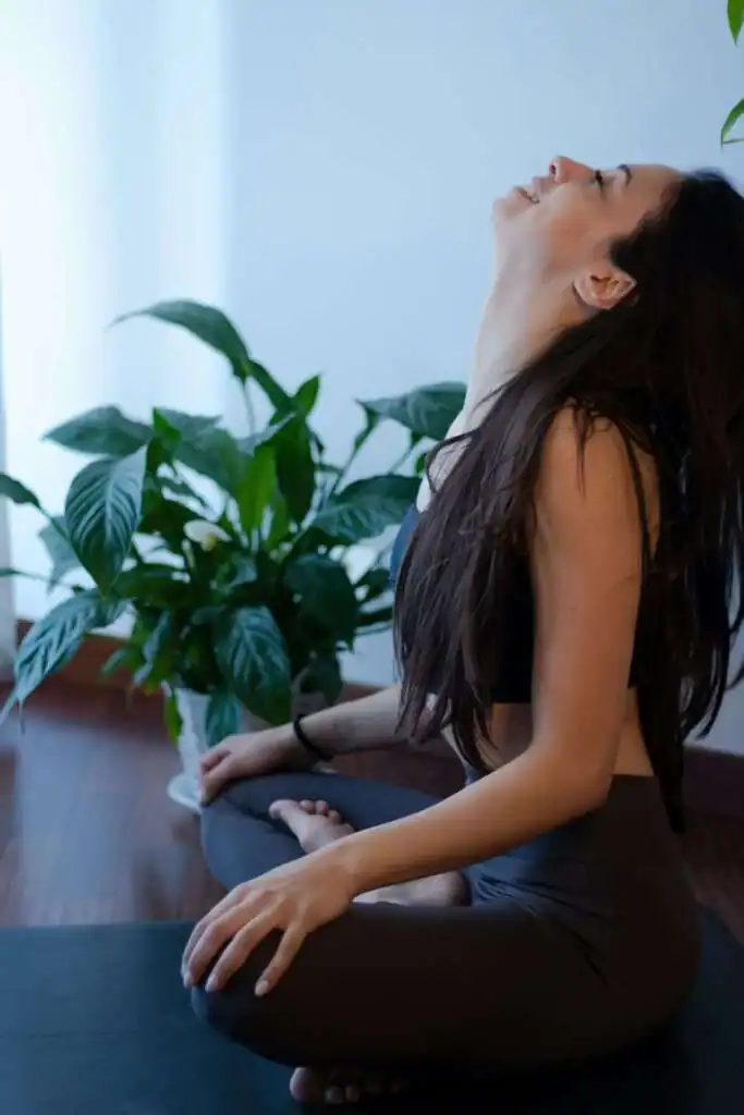 Woman-smiling-doing-yoga-at-home.-Saturday-self-care-routine