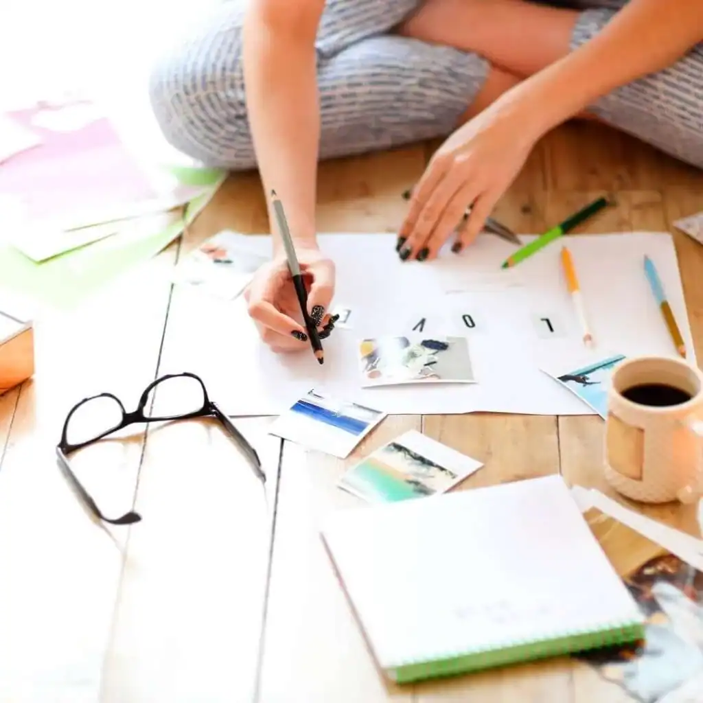 Young-Brunette-Woman-Creating-Her-Feng-Shui-Wish-Map-Using-Sciss.-Feminine-Vision-Board