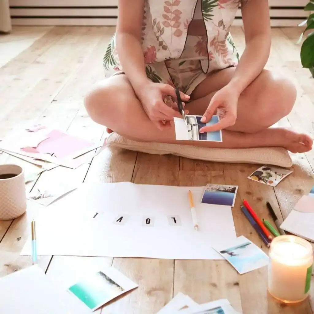 Young-Brunette-Woman-Creating-Her-Feng-shui-Wish-Map-Using-Sciss.-Feminine-Vision-Board