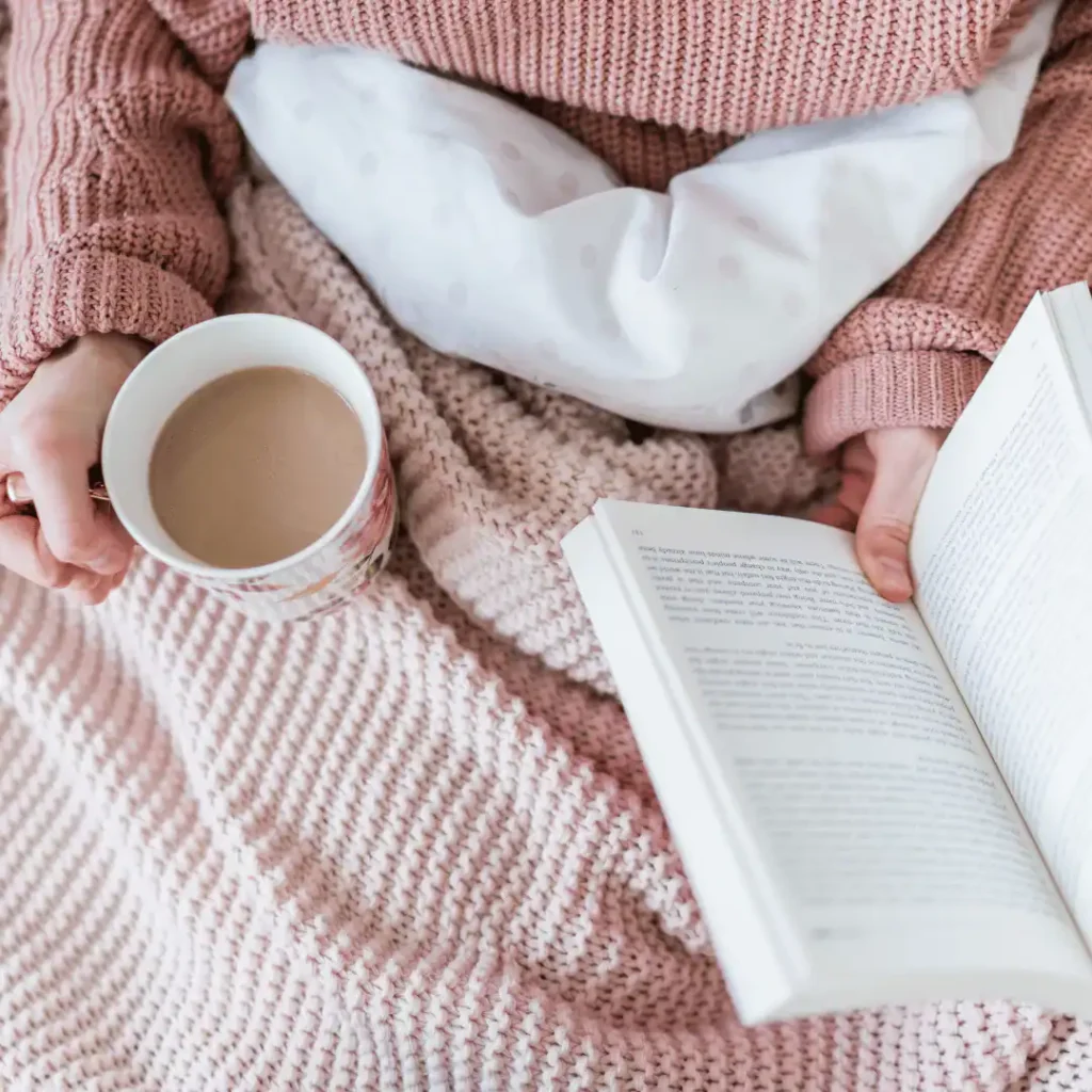 woman-reading-in-bed-with-a-cup-of-coffee-sunday-self-care-quotes