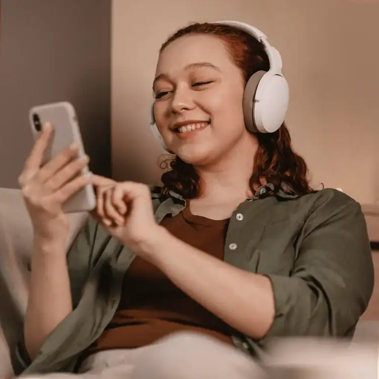 woman-using-modern-headphones-smartphone-devices-of-a-home.-Saturday-selfcare-ideas