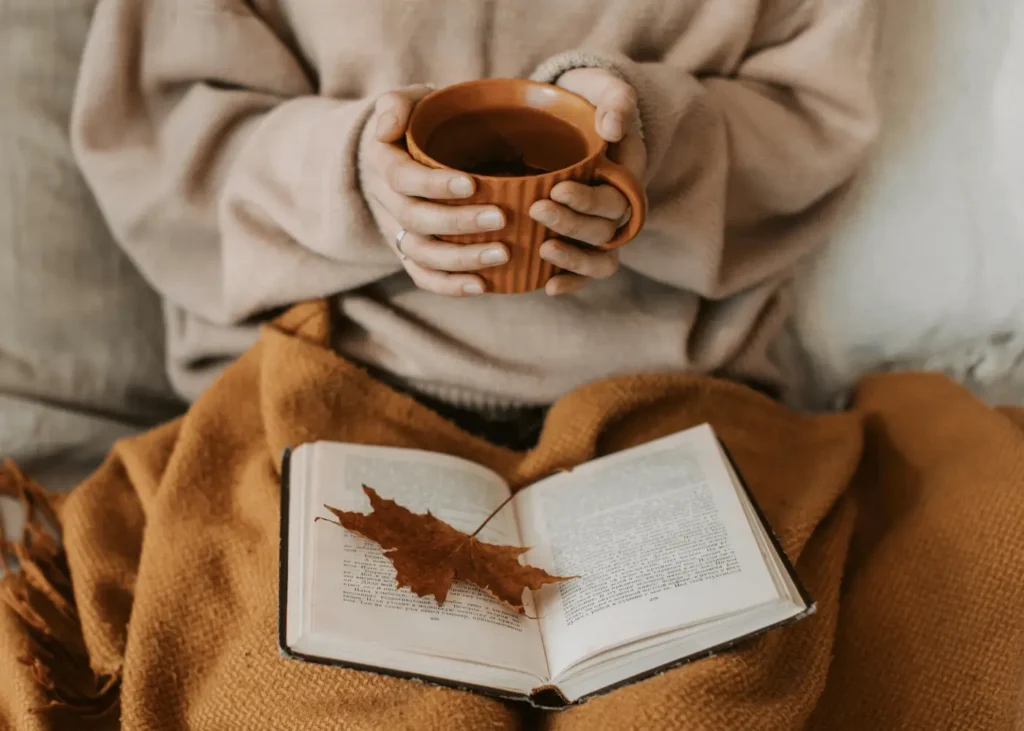 Person Holding a Cup of Tea. How to create a fall morning routine