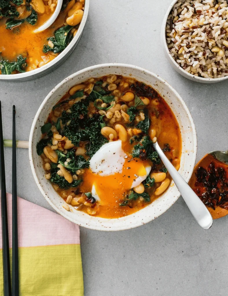 Spicy Chili Crisp White Bean and Barley Stew with Kale and Eggs