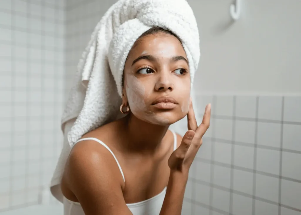 Woman Doing Skincare in Bathroom Mirror. self-care sunday ideas