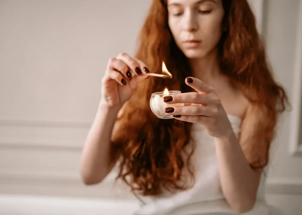 woman lighting a candle. Hobbies For Introverts