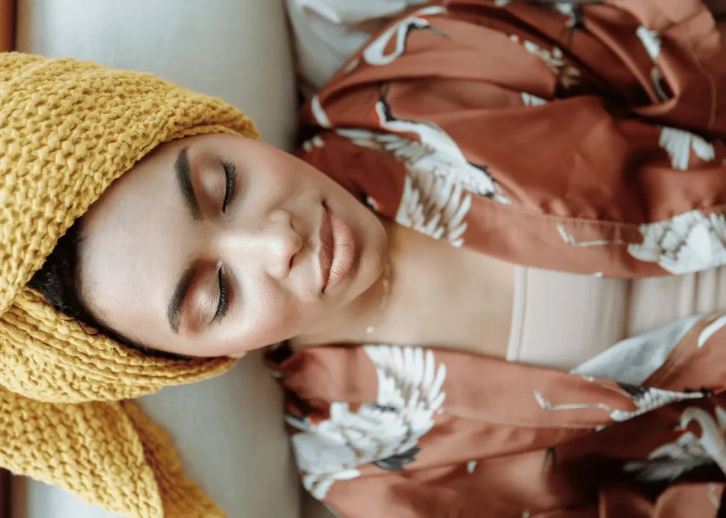 woman relaxing on the sofa with her eyes closed. New year affiirmations