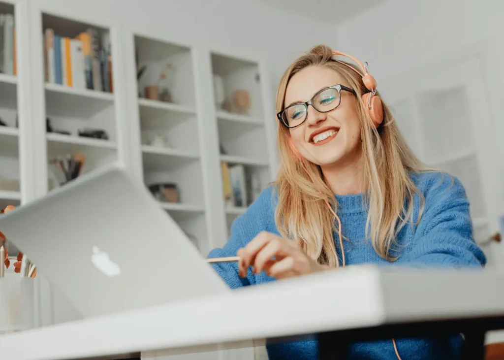 woman with headphones on working on her laptop