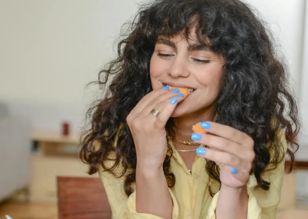 A Smiling Woman Eating Breakfast