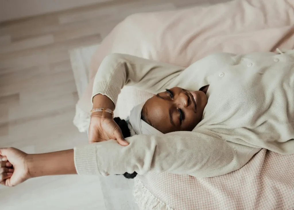 A Woman Stretching while Lying in Bed