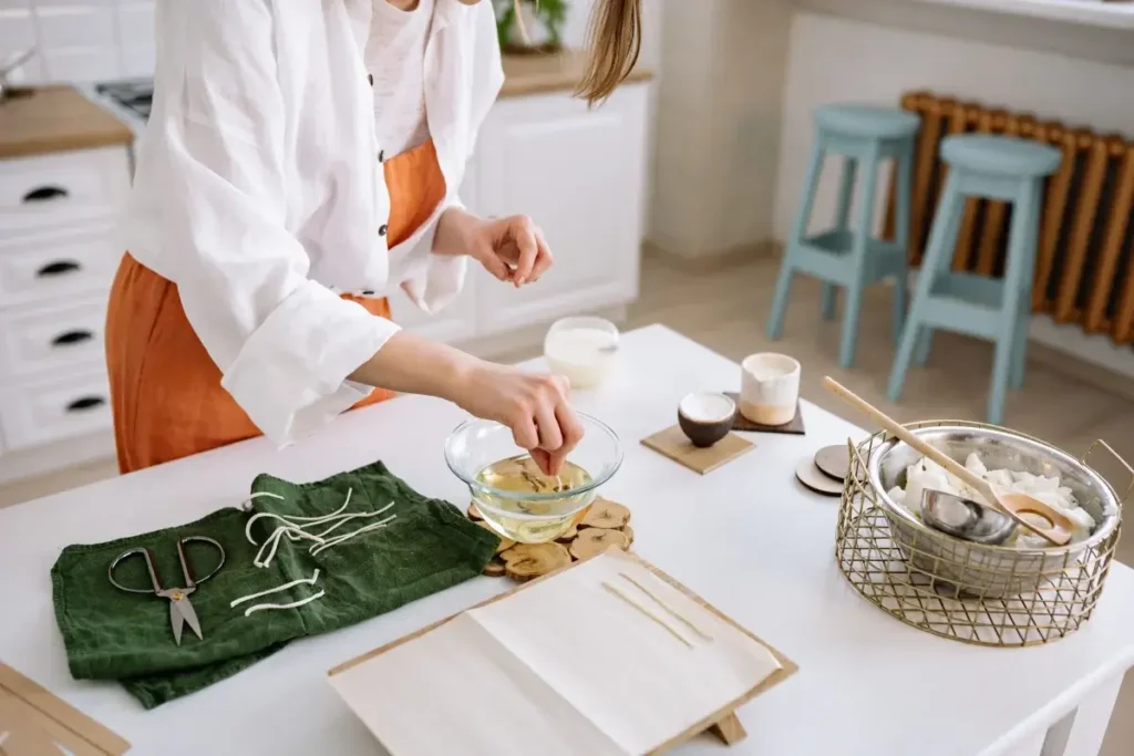 Artisan creates handmade candles in a cozy kitchen with tools and materials. Hobbies for Women Over 40