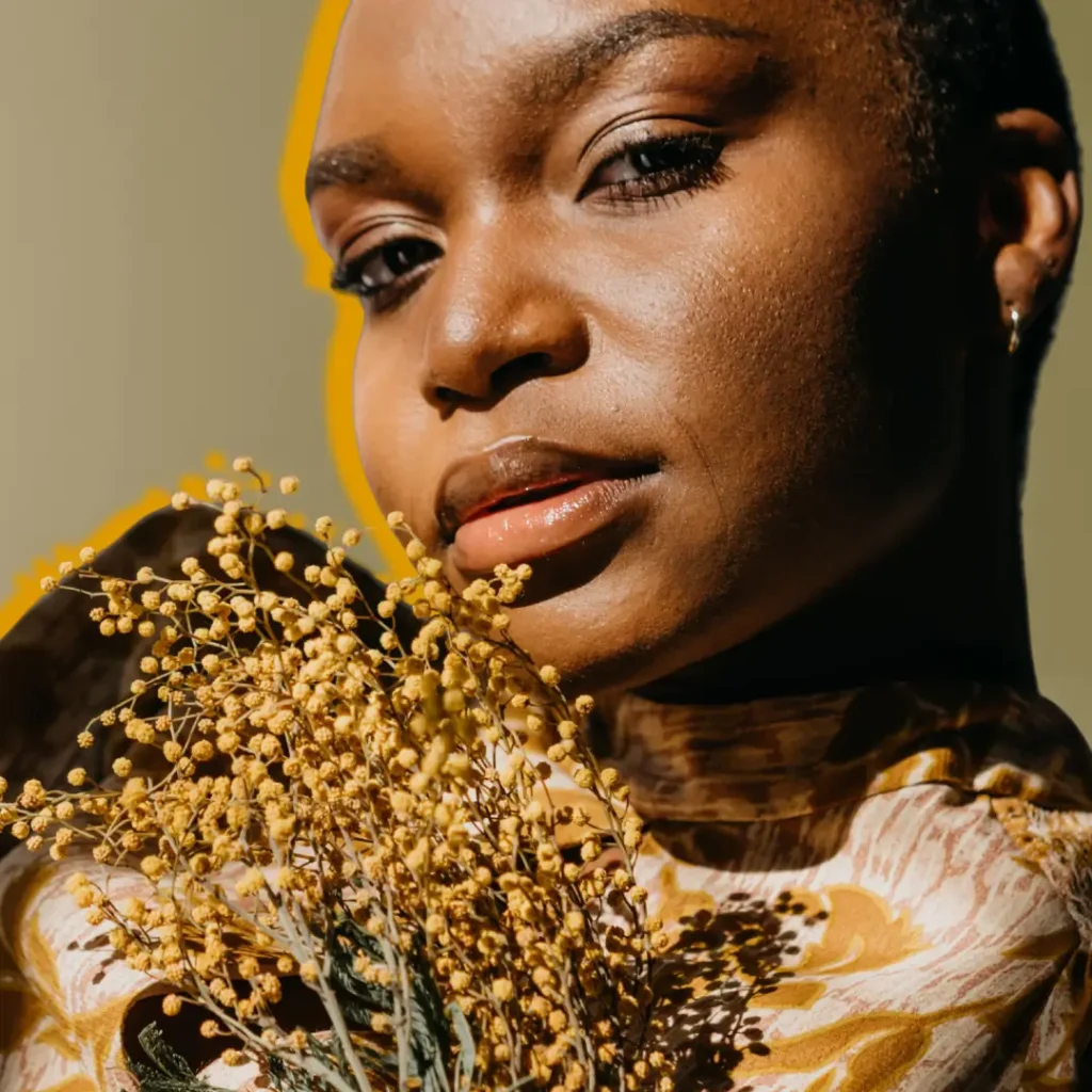 Close-up portrait of an elegant woman in floral attire, exuding glamour and style. Fall journal prompts