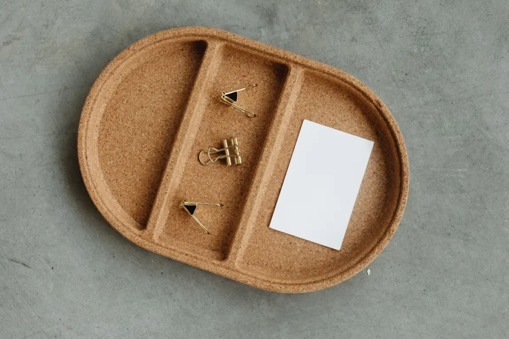 Simple cork tray with business card and binder clips on concrete. Why Cork Might Be the Most Underrated Material in Your Home