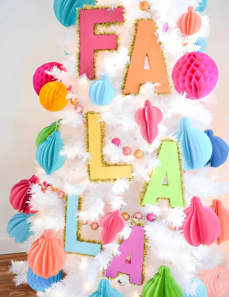 Cardboard letters spelling Fa La La, painted in bright colors and edged with gold tinsel.