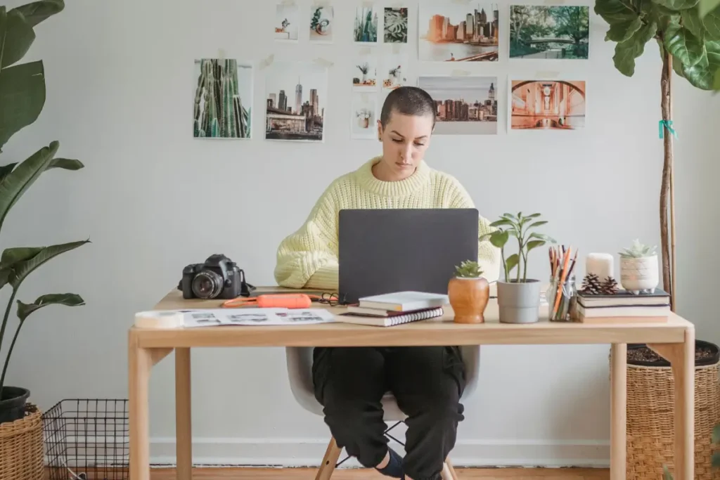 Small business owner working from a plant-filled home office.