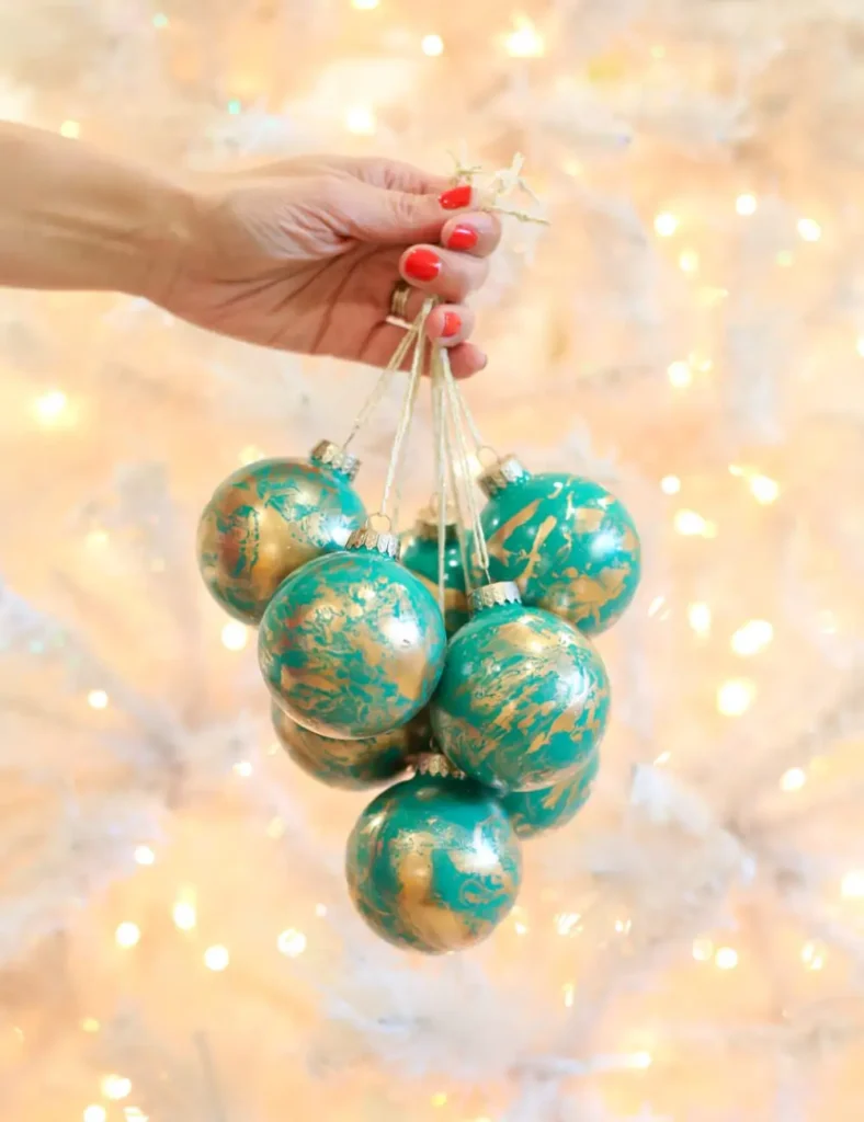 Emerald green glass Christmas ornaments with swirled gold marbling.