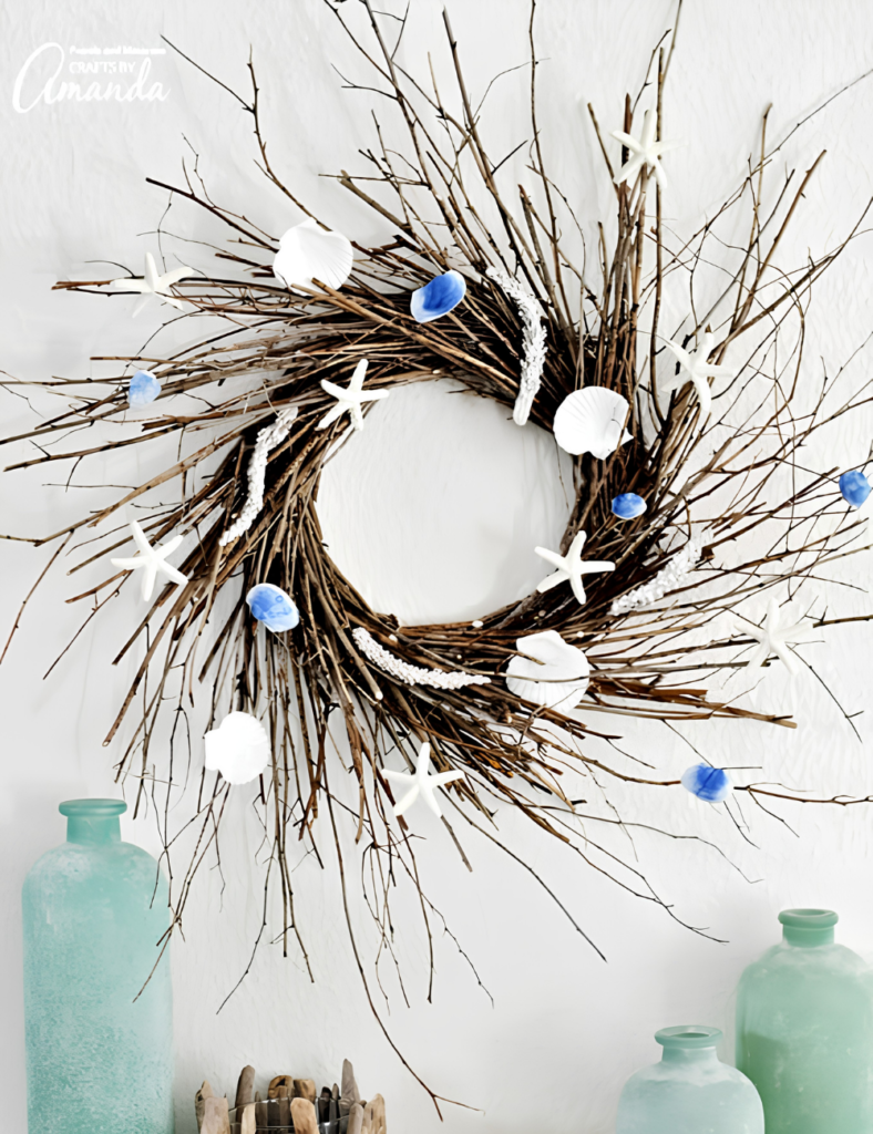 Large twig wreath made from collected sticks, decorated with starfish and seashells on a white wall