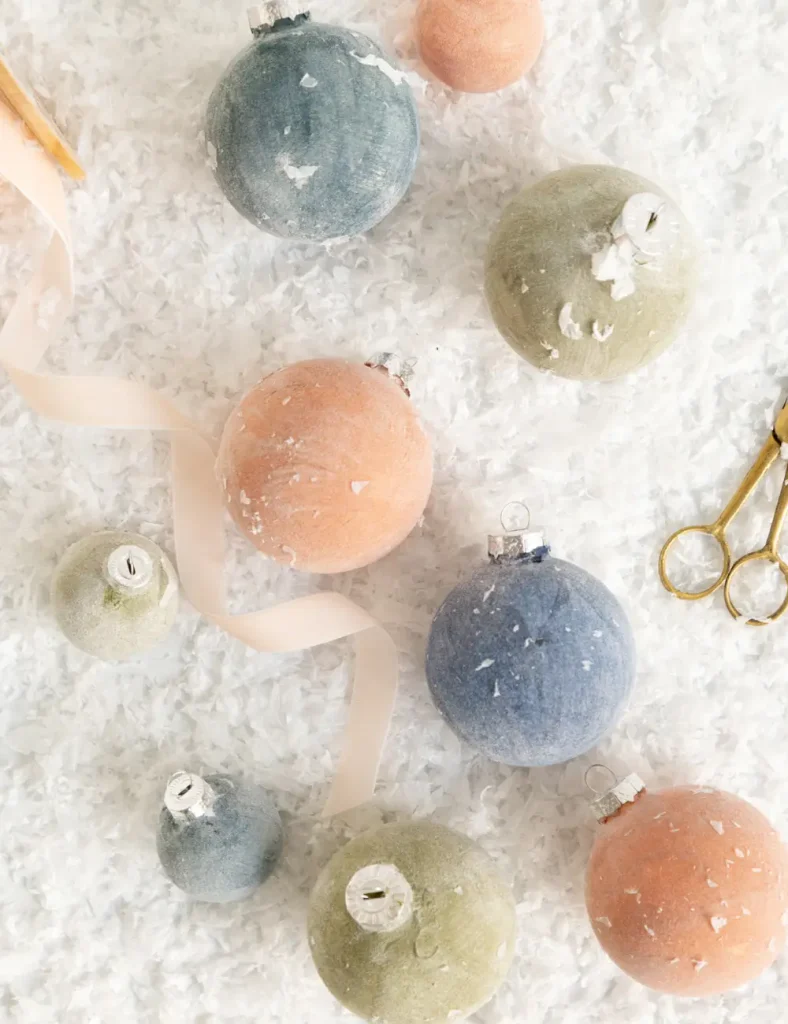 Matte velvet-look Christmas baubles in dusty pink, navy and bronze.