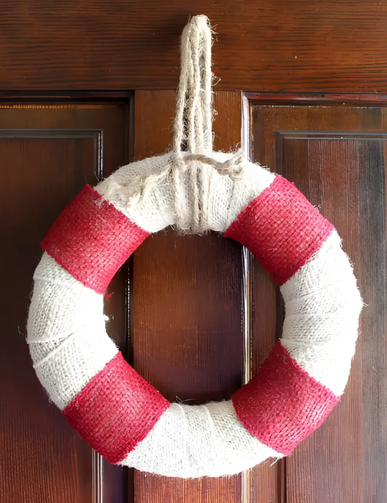 Red and white burlap beach wreath shaped like a life preserver hanging on a front door