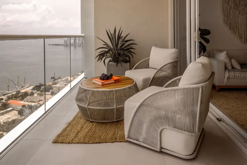 Stylish balcony with ocean view, outdoor seating, and modern decor. airbnb name ideas