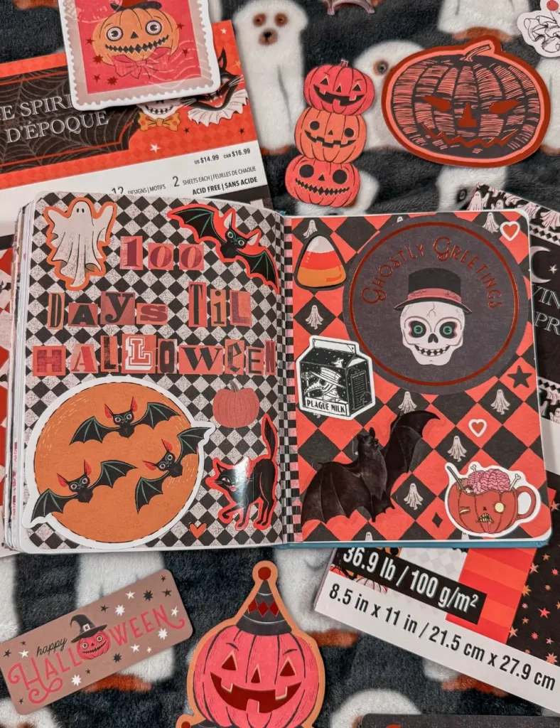 Halloween countdown journal page covered in vintage-style pumpkin, bat and black cat stickers on a checkered background