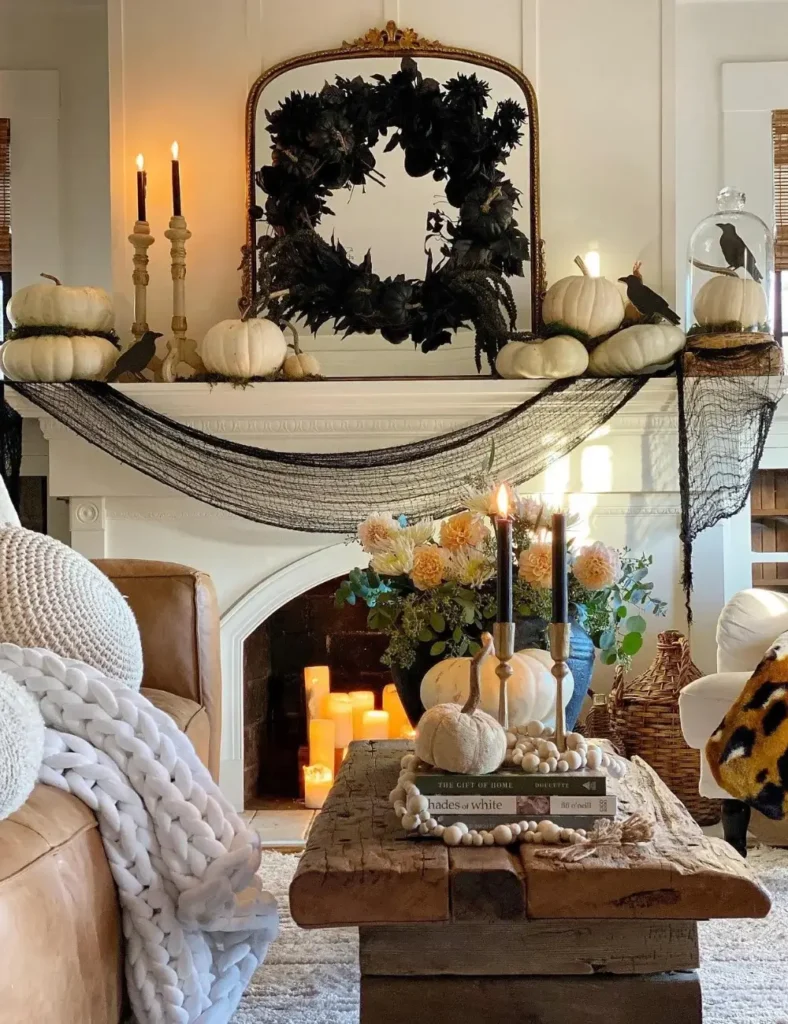 Rustic wood bench coffee table styled with a velvet pumpkin, gold taper candlesticks, a wood bead garland and a stack of books