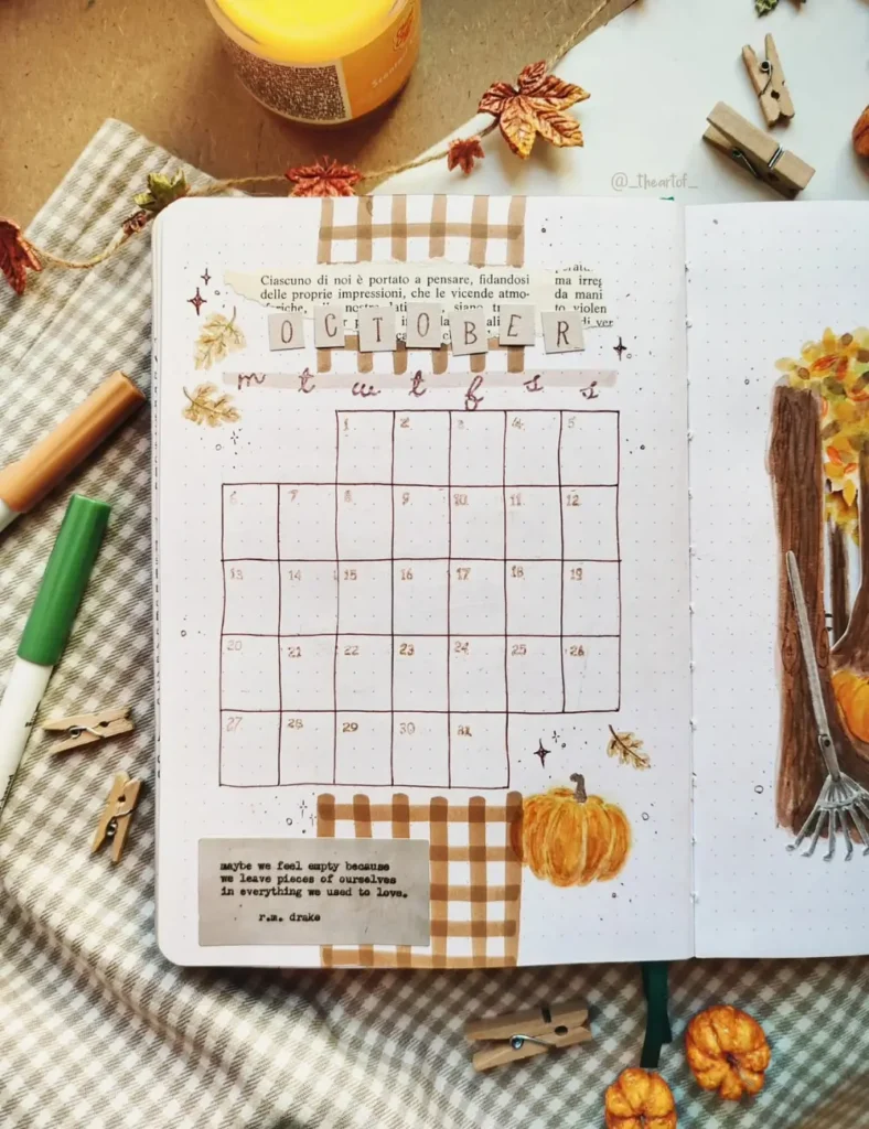 October monthly calendar grid decorated with gingham washi tape, a painted pumpkin and a torn book-page quote