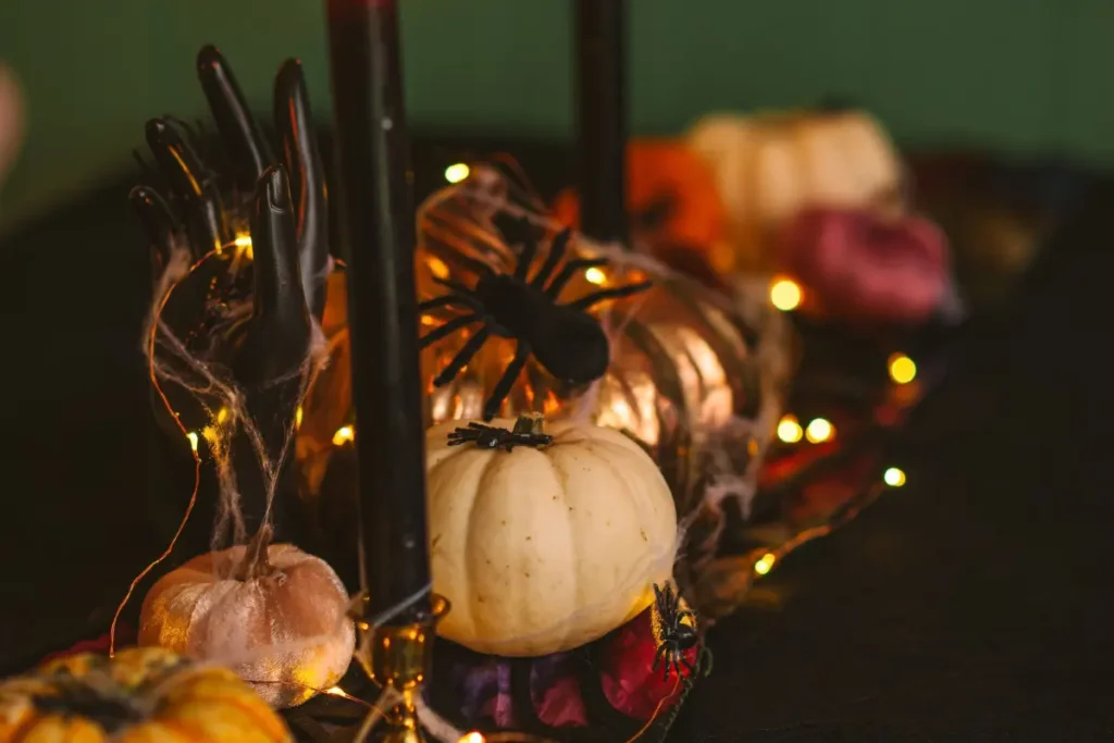 A festive Halloween table setting with pumpkins, candles, and decorative lights ideal for autumn celebrations