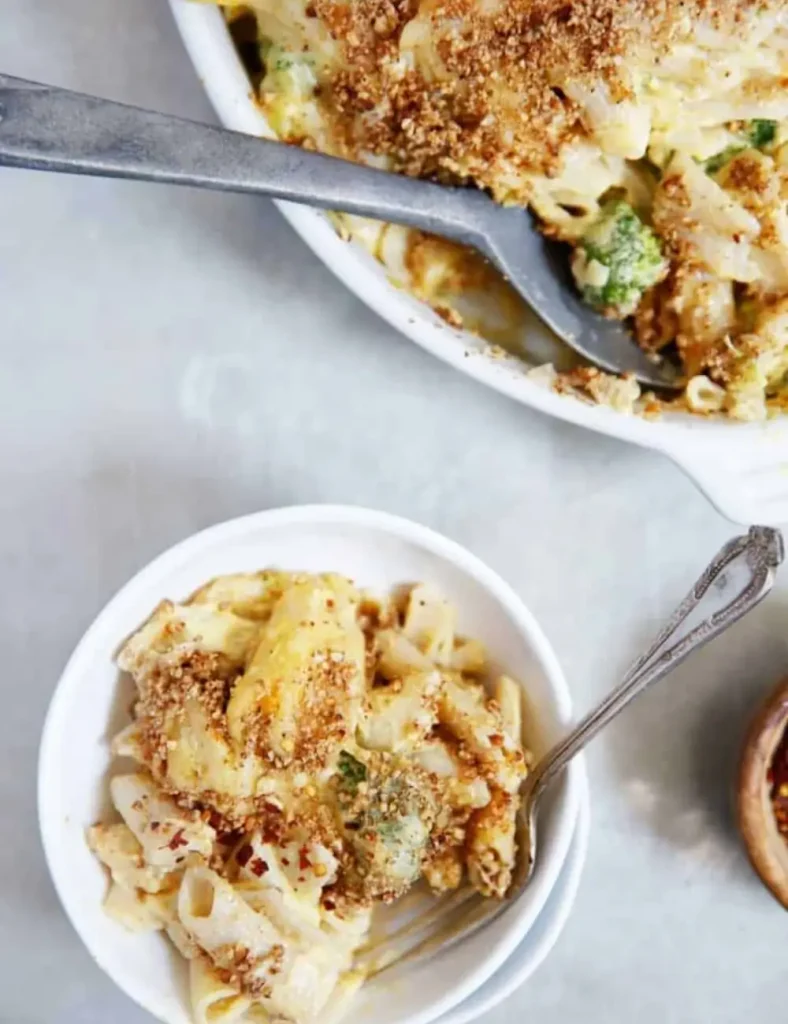 Baked butternut squash mac and cheese topped with golden pecan breadcrumbs in a baking dish