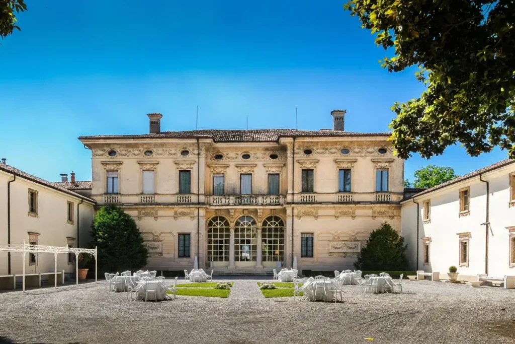 Beautiful courtyard of an Italian villa with outdoor seating under the summer sun