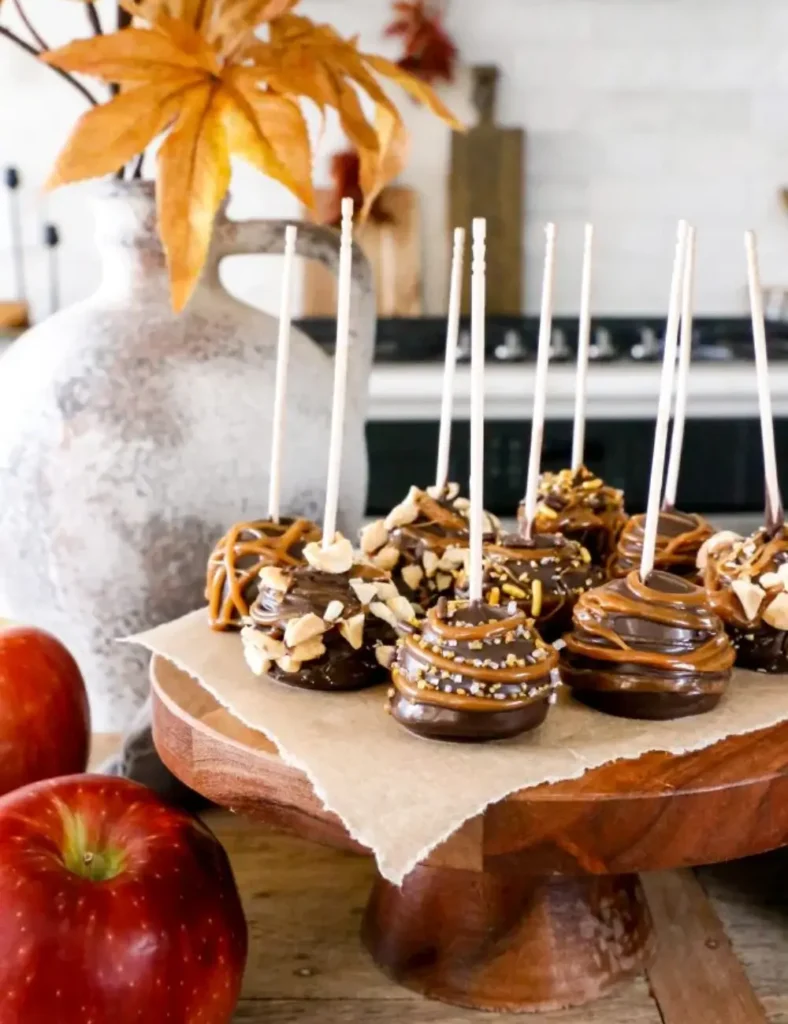 Bite-sized caramel apple pieces dipped in chocolate and topped with sprinkles