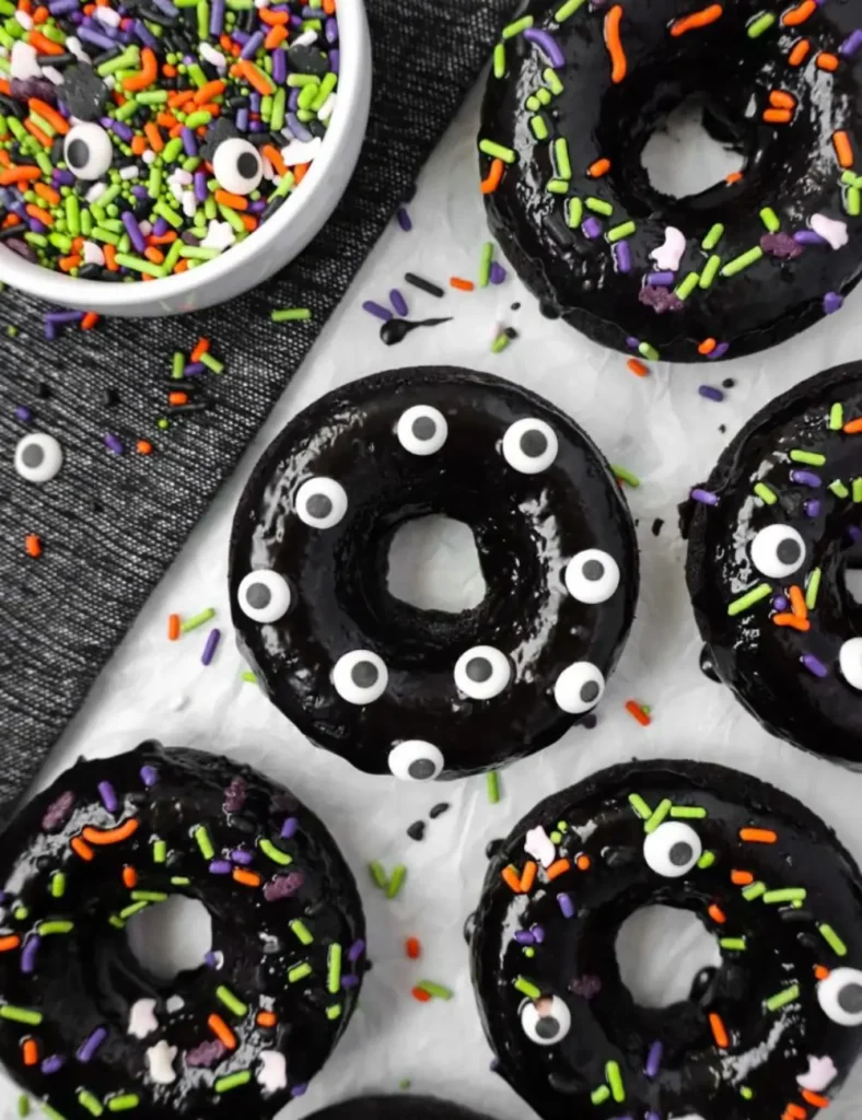 Black cocoa Halloween donuts with black glaze and Halloween sprinkles