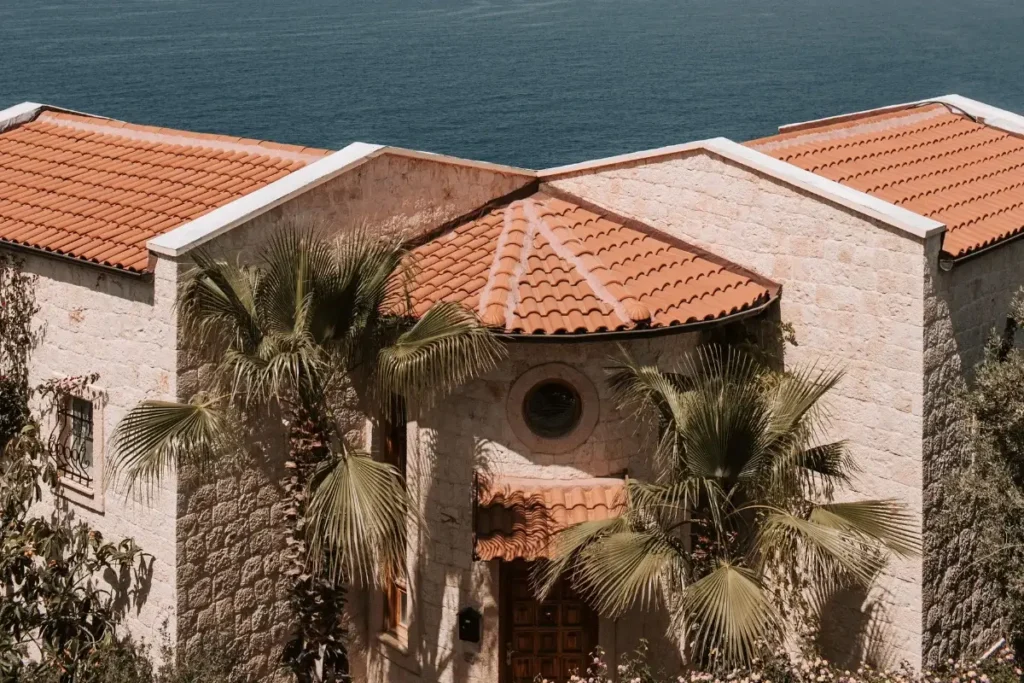 Charming villa in Antalya with red-tiled roofs and coastal views, embodying the Mediterranean essence