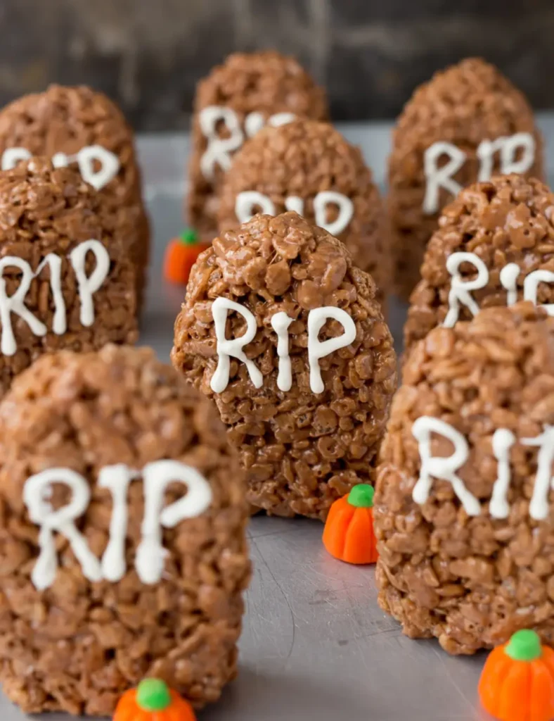 Chocolate Rice Krispie treats shaped like tombstones with _RIP_ written in white chocolate