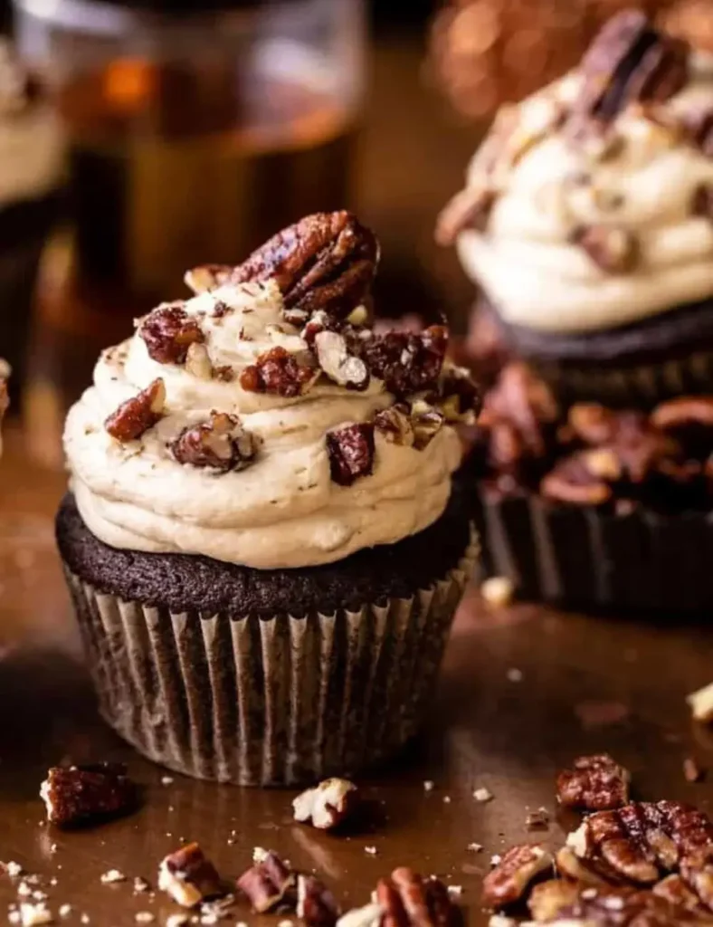 Chocolate cupcakes filled with pecan pie filling and topped with butter pecan frosting