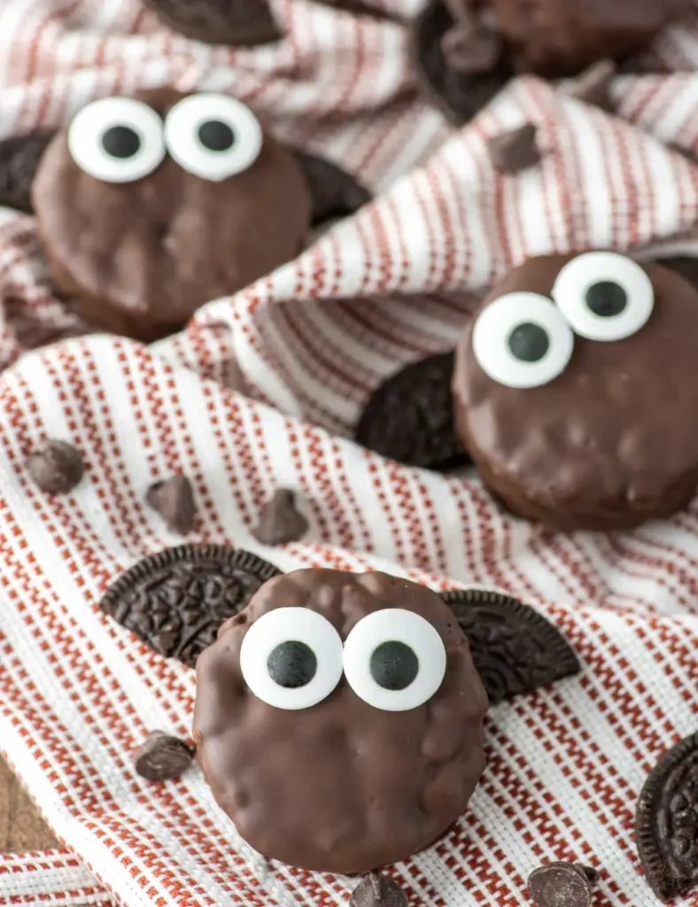 Chocolate-dipped Rice Krispie treats decorated as bats with Oreo cookie wings and candy eyes
