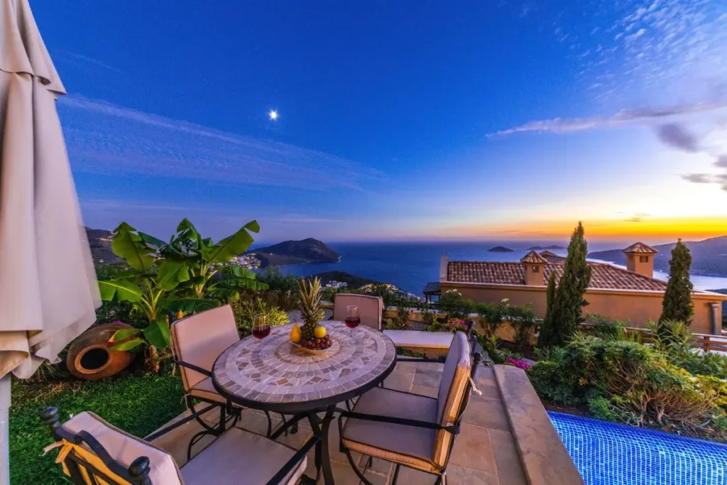 Elegant terrace dining with a stunning sea view during sunset, ideal for relaxation and leisure