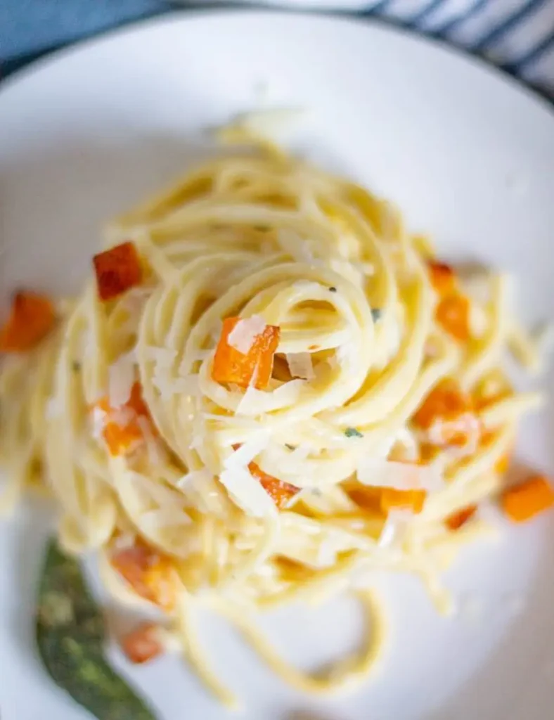 Fall pasta in creamy goat cheese sauce with roasted butternut squash, pine nuts and crispy sage
