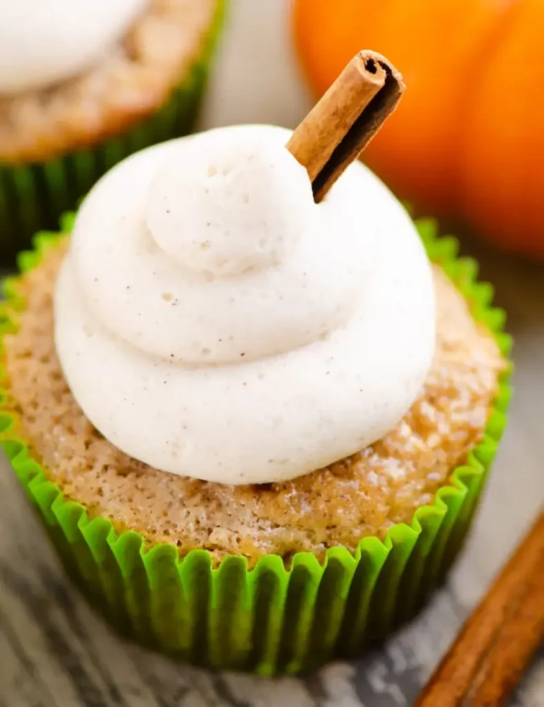 Fall spiced cupcakes topped with swirled cinnamon buttercream and a cinnamon stick garnish