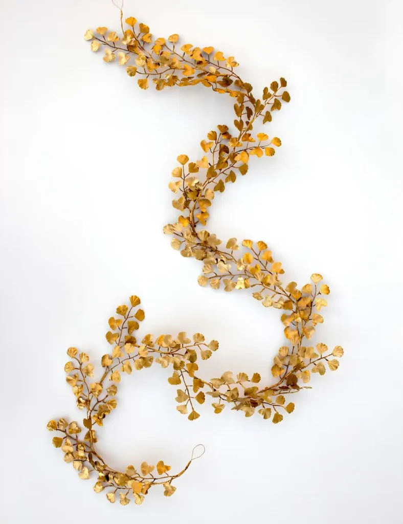 Gold spray-painted faux leaf garland with metallic sheen