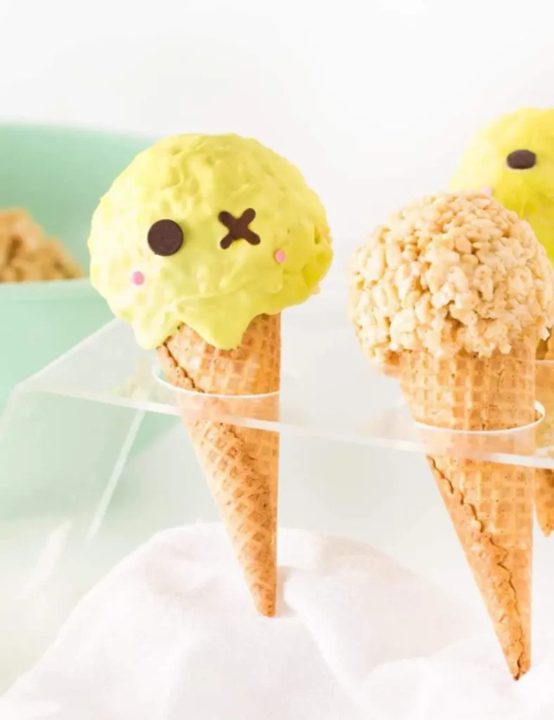 Ice cream cone Rice Krispie treats decorated as green zombies with X eyes