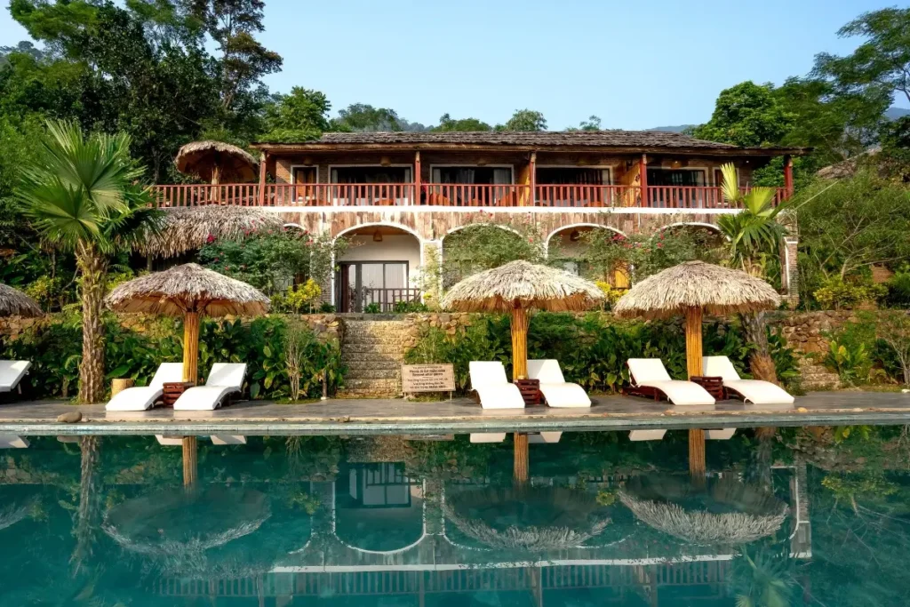 Idyllic tropical resort featuring poolside lounge chairs and thatched umbrellas