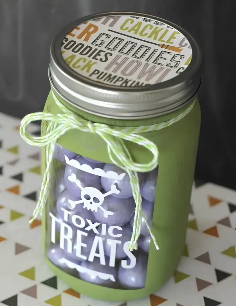 Mason jar painted matte black with a _toxic_ label and filled with purple candy as a Halloween gift