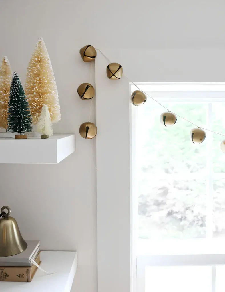 Oversized gold jingle bells strung as a simple garland across a window